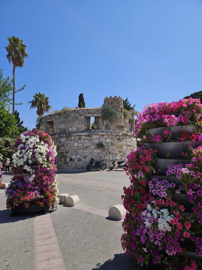 Nerantzia Castle with pink flowers in front 