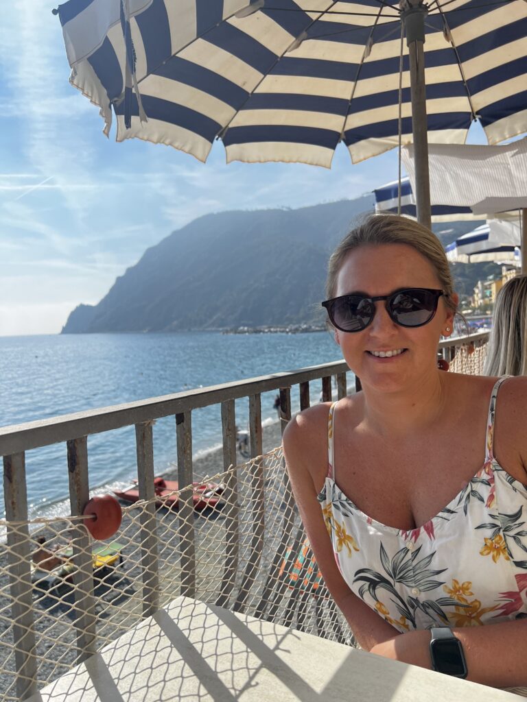 Enjoying lunch in Monterosso with blue and white umbrella in full view